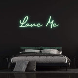 LED Neon Sign – 'Love Me' wall decor for bedrooms or events, perfect for creating a romantic and inviting ambiance.