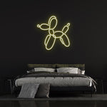 Yellow LED neon light of a balloon dog, trendy wall decor with neon light art for home interior.