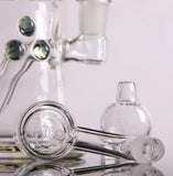 Close-up of Bear Quartz x Kenta Kito glass rig accessories, including carb cap and dab tools, designed for efficient dabbing setups
