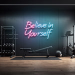 LED neon sign with the motivational quote "Believe in Yourself" displayed in a home gym, perfect for inspiring workouts and modern décor.

