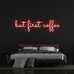 Red "But First Coffee" LED neon sign featured in a trendy bedroom with a black background, perfect for coffee-inspired wall decor.