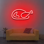 Chicken LED neon sign glowing in red color, enhancing the decor of a contemporary living room, suitable for home and business settings.


