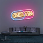Chill Pill LED neon sign for modern wall art, adding a fun and vibrant aesthetic to living room decor with bright pink and blue lighting.