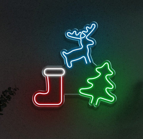 LED neon sign displaying Christmas icons: a glowing blue reindeer, green tree, and red stocking, perfect for holiday decorations and festive lighting.