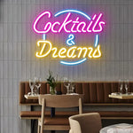 LED neon sign displaying "Cocktails & Dreams" in vibrant colors, perfect for bar and restaurant decor, enhancing ambiance and nightlife vibes.