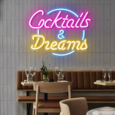 LED neon sign displaying "Cocktails & Dreams" in vibrant colors, perfect for bar and restaurant decor, enhancing ambiance and nightlife vibes.