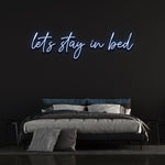 Create a cozy vibe in your bedroom with the 'Let's Stay in Bed' LED neon sign.