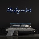 Create a cozy vibe in your bedroom with the 'Let's Stay in Bed' LED neon sign.