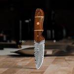 Damascus Hunter Fixed Blade Knife with a micarta and rosewood handle, standing elegantly on a wooden table.