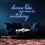 Blue neon sign with the quote "Dance like no one is watching" on a navy blue background, paired with contemporary furniture. Perfect for living room decoration or event setups.