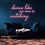 Pink neon sign displaying "Dance like no one is watching" installed in a stylish home setting, offering vibrant lighting for any room or celebration.