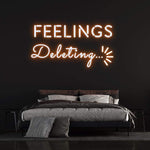 Deleting Feelings neon sign with orange light, perfect for modern bedroom decor and emotional wall art.