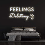 Deleting Feelings neon sign with white light, enhancing bedroom aesthetic and trendy wall decor.