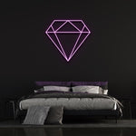 purple diamond-shaped LED neon sign on black wall in modern bedroom with bed and pillows.