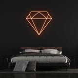 Orange diamond-shaped LED neon sign on black wall in stylish bedroom with bed and pillows.