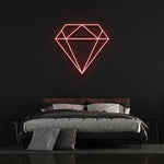  Red diamond-shaped LED neon sign on black wall in modern bedroom with bed and pillows.