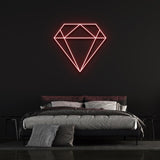  Red diamond-shaped LED neon sign on black wall in modern bedroom with bed and pillows.
