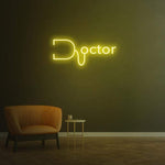 Yellow doctor LED neon sign on dark room wall with modern chair, vibrant medical neon lighting decoration.