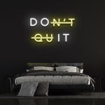 Don't Quit yellow and white LED neon sign as bedroom decor to create a motivational atmosphere.