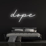 Dope LED neon sign in white light above a modern bed, perfect for home decor or bedroom wall art.