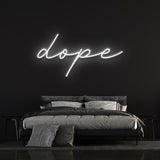 Dope LED neon sign in white light above a modern bed, perfect for home decor or bedroom wall art.