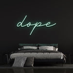Dope LED neon sign in green color adding a unique touch to a black-walled bedroom with contemporary design.