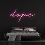 Dope LED neon sign in pink color mounted on a black wall above a modern bed, ideal for trendy bedroom wall decor.