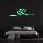 Double heart green neon sign perfect for a modern bedroom wall.
