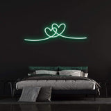 Double heart green neon sign perfect for a modern bedroom wall.