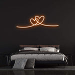 Double heart orange neon wall sign for cozy and modern bedroom decor.