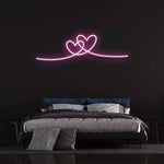 Double heart pink neon wall sign for bedroom decor and romantic ambiance.