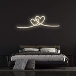 Double heart warm white neon sign for stylish bedroom wall decor.