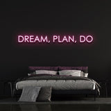 Pink "Dream, Plan, Do" LED neon sign in a modern bedroom setup.