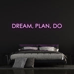 Purple "Dream, Plan, Do" LED neon sign enhancing bedroom decor.