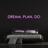 Purple "Dream, Plan, Do" LED neon sign enhancing bedroom decor.