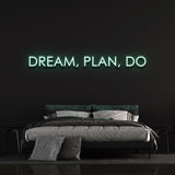 Warm white "Dream, Plan, Do" LED neon sign adding subtle bedroom lighting.