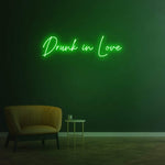 Drunk in Love green LED neon sign as chic wall decor for contemporary interiors.