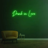 Drunk in Love green LED neon sign as chic wall decor for contemporary interiors.
