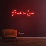 Drunk in Love red LED neon sign creating a romantic atmosphere in the room.