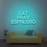 Eat Pray Espresso LED neon sign with a vibrant blue glow, adding a cozy vibe to the room.