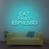 Eat Pray Espresso LED neon sign with a vibrant blue glow, adding a cozy vibe to the room.