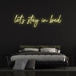 Sustainable 'Let's Stay in Bed' LED neon sign for long-lasting brightness and bedroom decor."