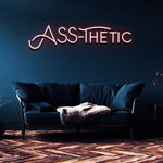 Funny LED Neon Sign – 'ASS-THETIC' wall decor for home or studio, available in multiple sizes and colors for a lively and unique style.