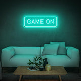 Seegreen GAME ON LED neon sign with modern white couch and a coffee table in the room.