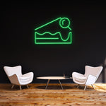 Green Cheesecake LED neon sign for wall decor, ideal for modern home or cafe interiors.