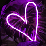 Heart neon sign in hot pink, a bold and stylish illuminated wall decor ideal for creating a cozy and romantic atmosphere.