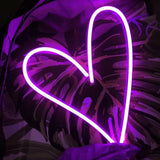 Heart neon sign in hot pink, a bold and stylish illuminated wall decor ideal for creating a cozy and romantic atmosphere.