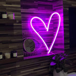 "Heart neon sign in light pink, a soft and elegant illuminated decor choice, perfect for a playful and inviting ambiance in any room.