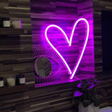"Heart neon sign in light pink, a soft and elegant illuminated decor choice, perfect for a playful and inviting ambiance in any room.