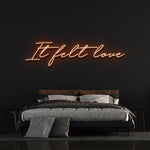 It Felt Love LED Neon Sign in radiant orange, stylish wall decor for home or events, featuring energy-efficient LED lights with durable acrylic backing.